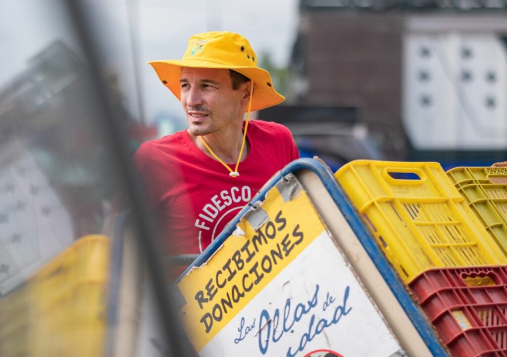 Un volontaire récolte les invendus d'un marché pour une collecte solidaire.